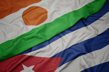 waving colorful flag of cuba and national flag of niger.