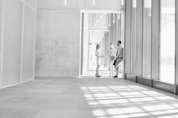 Black and white photo of business people discussing plans before meeting