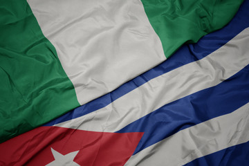 waving colorful flag of cuba and national flag of nigeria.