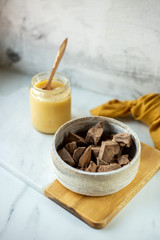 condensed coconut milk and Chocolate Shavings. Raw cacao mass