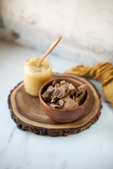 Fototapeta na wymiar condensed coconut milk and Chocolate Shavings. Raw cacao mass