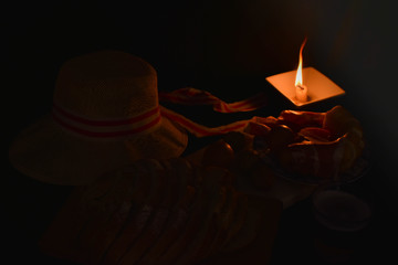 the darkness of a table in darkness by a candle