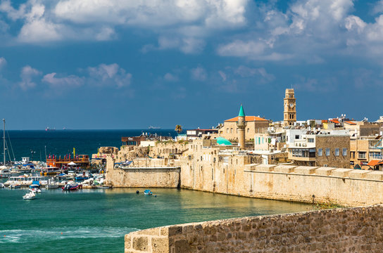  View on marina with yachts and ancient walls of harbor in Acre or Akko, Israel.