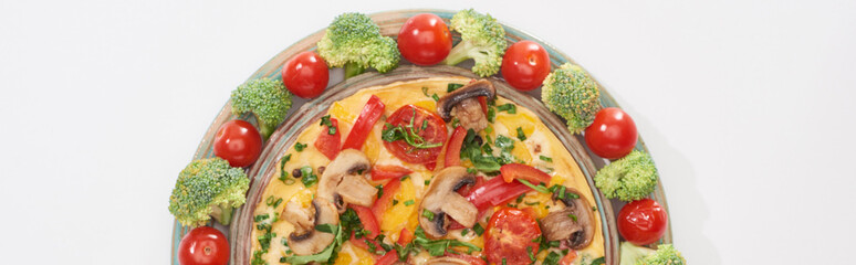 top view of yummy omelet on plate with fresh tomatoes and broccoli