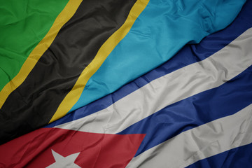 waving colorful flag of cuba and national flag of tanzania.