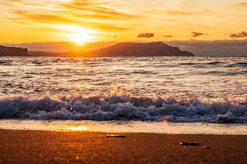 Fototapeta na wymiar picturesque sunrise over the Black Sea, waves roll on the sand
