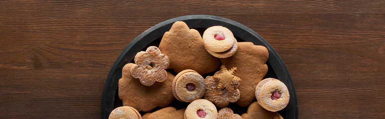 top view of Christmas cookies in pan on wooden table, panoramic shot
