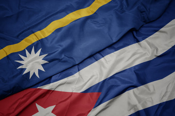 Naklejka premium waving colorful flag of cuba and national flag of Nauru .