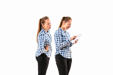 Young handsome woman arguing with herself on white studio background. Concept of human emotions,...