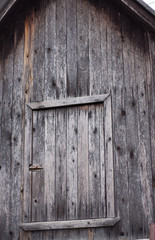 An old door on a pediment of old boards.