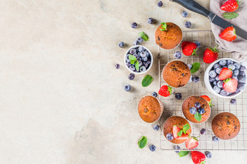 Obraz na płótnie Canvas Homemade vanilla muffins or cupcakes with berries