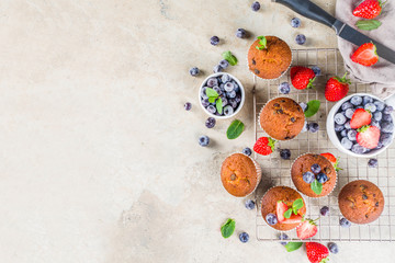 Homemade vanilla muffins or cupcakes with berries