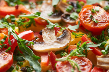 close up of delicious omelet with mushrooms, tomatoes and greens