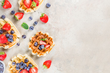 Fototapeta na wymiar Sweet Homemade Breakfast Belgian Waffles with Berries - Strawberry and Blueberry