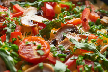 close up of tasty homemade omelet with mushrooms, tomatoes and greens