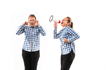 Young handsome woman arguing with herself on white studio background. Concept of human emotions, expression, mental issues, internal conflict, split personality. Half-length portrait. Negative space.