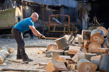 Lumberjack splitting wood with an axe