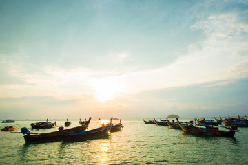 Sunrise sea beach with wooden boat white sand beach