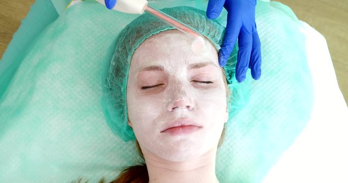 Woman getting electric darsonval facial therapy in salon