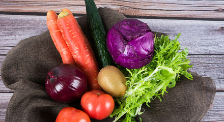 Healthy food. Vegetables and fruits. On a black wooden background. Top view. Copy space.