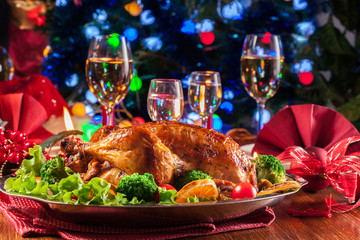 Baked or roasted whole chicken on Christmas table