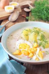 Traditional polish soup Zurek. Sour soup with sausage,  potatoes and eggs