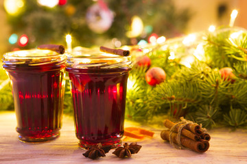 Christmas mulled wine on wooden plank over christmas tree