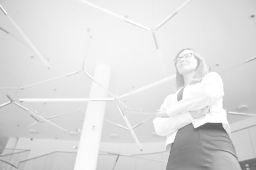Black and white photo of businesswoman  while standing at office