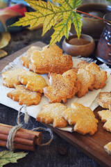 Autumn coffee break: cinnamon cookies in form of maple leaves, coffee and yellow leaves