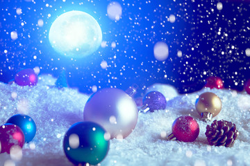 Naklejka na ściany i meble Christmas background with Christmas balls on snow over fir-tree, night sky and moon. Shallow depth of field. The elements of this image furnished by NASA