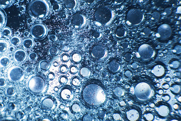 abstract light blue background with oil circles .  bubbles of water close up . oil bubbles in the water macro.  circle bubbles  background