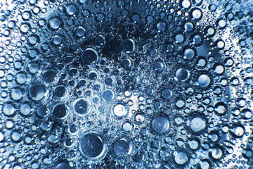 abstract light blue background with oil circles .  bubbles of water close up . oil bubbles in the water macro.  circle bubbles  background
