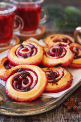  Sweet cranberry roll buns with chocolate drops and two cups of cranberry fruit drink