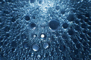abstract light blue background with oil circles .  bubbles of water close up . oil bubbles in the...