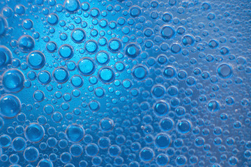 abstract light blue background with oil circles .  bubbles of water close up . oil bubbles in the water macro.  circle bubbles  background