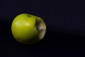 green apple on black background