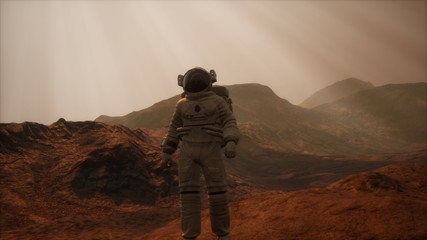Spaceman walks on the red planet Mars. Space Mission. Elements of this image furnished by NASA