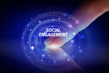 Finger touching tablet with social media icons and SOCIAL ENGAGEMENT