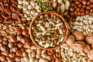 Natural healthy background made from different kinds of mix nuts like walnuts, hazelnut, pistachio, almond, cashew, pecans.