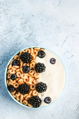 Bowl filled with corn ring cereals and berries. Healthy breakfast