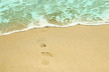 footprints in the sand on the beach