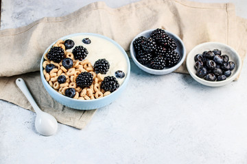 Fototapeta na wymiar Bowl filled with corn ring cereals and berries. Healthy breakfast