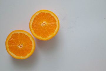 Orange fruit  cut in half on white