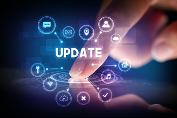 Finger touching tablet with web technology icons and UPDATE inscription, web technology concept