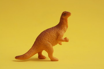 plastic toy with dinosaur shape in color background