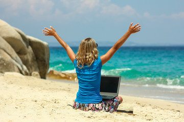 girl with laptop by the sea