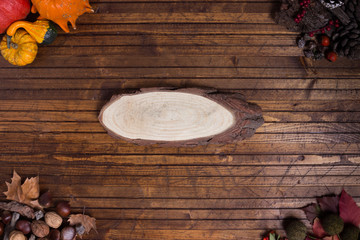 Autumnal frame in a wood background with a piece of wood in the middle