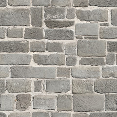 Seamless texture of sidewalk pavement made of marble blocks with notches. Pisa. Italy.