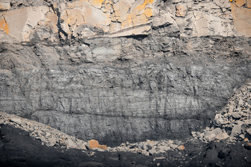 Geological section of soil, layers of coal and rock. Overburden open mine anthracite. Dark texture black color