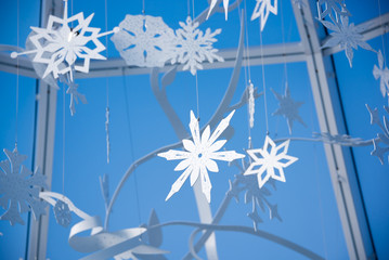 Winter snowflakes festive decoration against blue sky